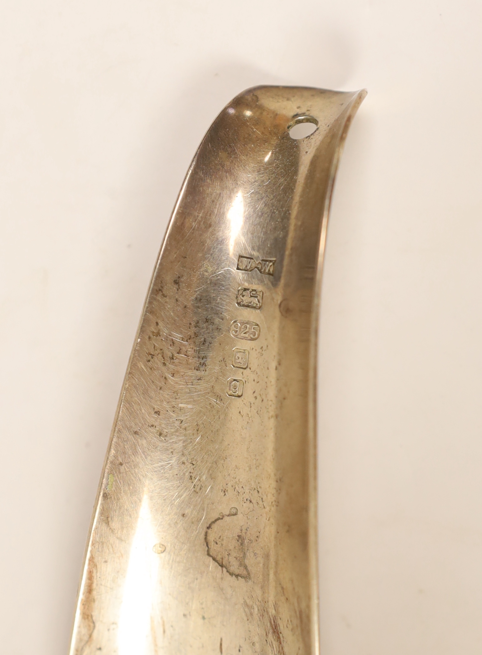 A modern pair of silver mounted wine coasters, diameter 91mm, a George V silver five bar toast rack by William Hutton & Sons, a modern silver shoehorn and a modern silver book mark.